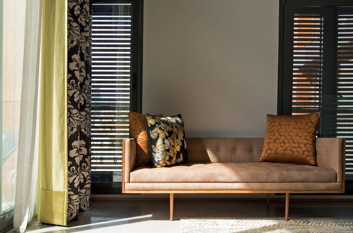 The mezzanine lounge in Amin Sammakieh's Beirut home, with furniture from Kocache Interiors and Andrew Martin and art by Sabhan Adam